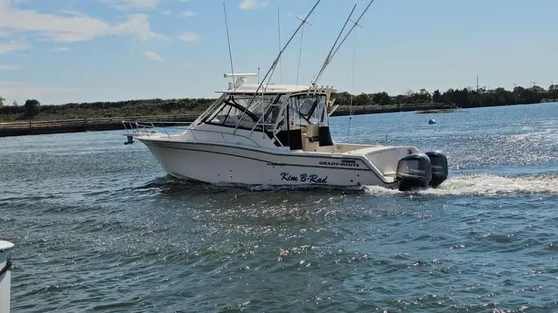 Slide: The Image of 2016 Grady-White Express 330 boat cruising on a sunny day in open water. - 2