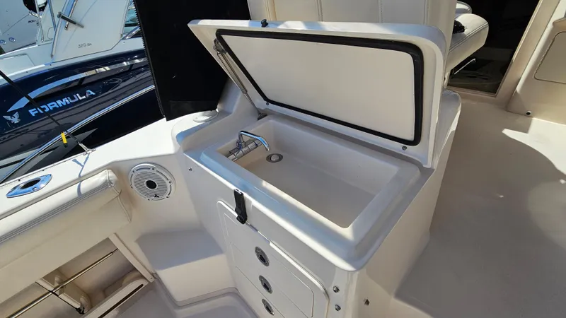 Slide: The Image of 2016 Grady-White Express 330 boat interior with open storage compartment. - 23