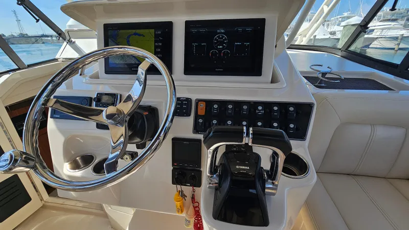 Slide: The Image of 2016 Grady-White Express 330 helm with steering wheel and control panel. - 30