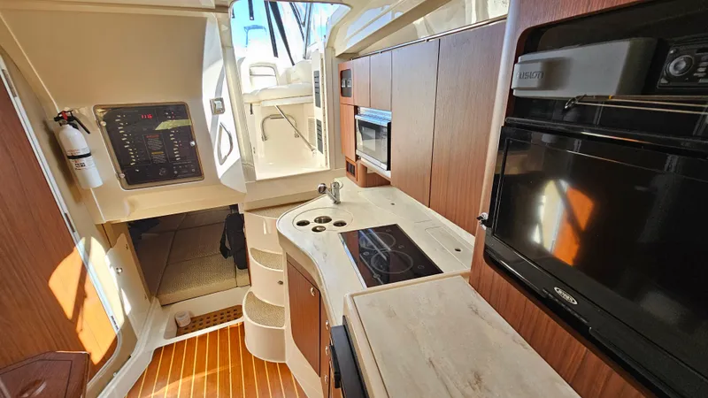 Slide: The Image of Interior of 2016 Grady-White Express 330 boat with modern kitchen amenities. - 49