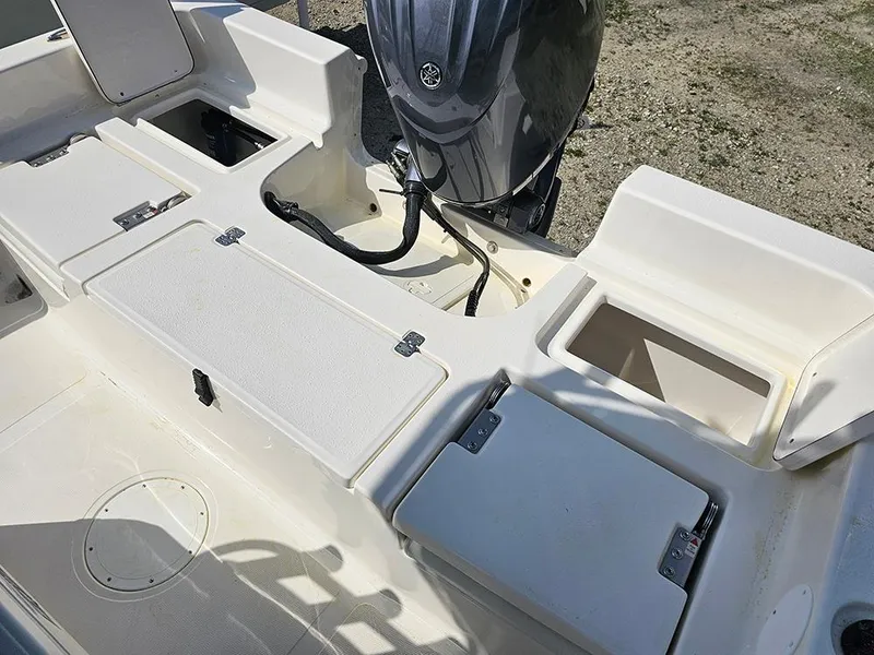 Slide: The Image of 2025 Bulls Bay 2200 XS boat interior with storage compartments and outboard motor. - 10