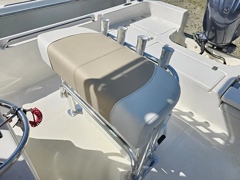 Slide: The Image of 2025 Bulls Bay 2200 XS boat interior with beige seating and rod holders. - 12