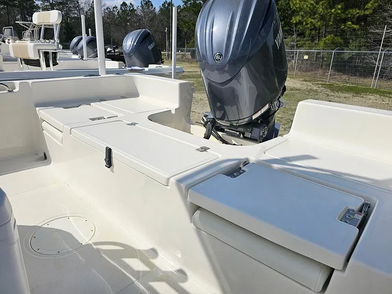 Slide: The Image of 2025 Bulls Bay 2200 XS boat interior with outboard motor, showcasing seating and storage. - 9