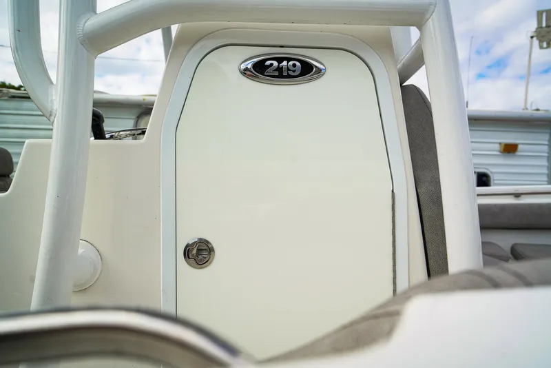 Slide: The Image of 2021 Sea Pro 219 CC boat console with storage compartment and lock. - 13