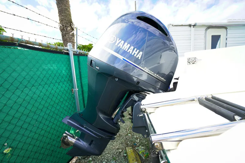 Slide: The Image of Yamaha outboard motor on 2021 Sea Pro 219 CC boat, parked near green fence. - 15