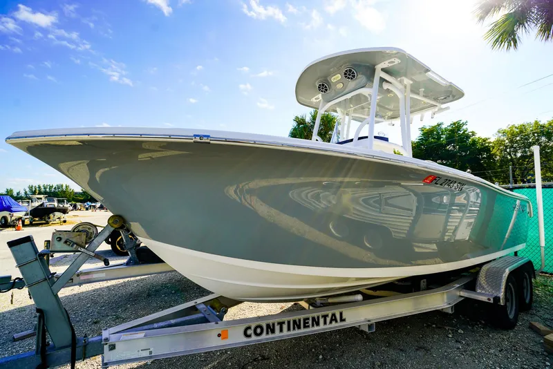 Slide: The Image of 2021 Sea Pro 219 CC boat on trailer under clear blue sky. - 16