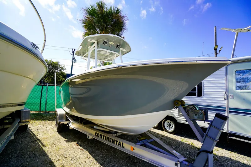 Slide: The Image of 2021 Sea Pro 219 CC boat on trailer, parked outdoors under blue sky. - 17