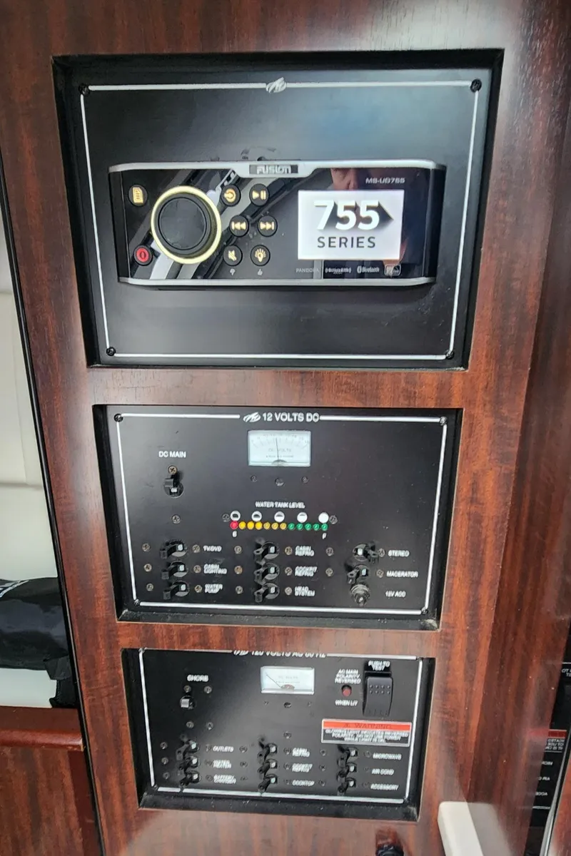 Slide: The Image of Control panel of 2018 Monterey 275 Sport Yacht with audio system and electrical switches. - 11
