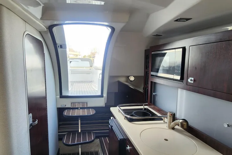 Slide: The Image of Interior of 2018 Monterey 275 Sport Yacht with kitchenette and seating area. - 12