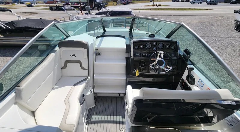 Slide: The Image of 2018 Monterey 275 Sport Yacht interior with helm, seating, and dashboard controls. - 5