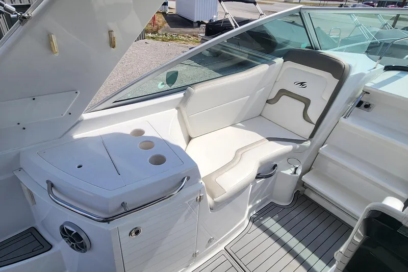 Slide: The Image of 2018 Monterey 275 Sport Yacht interior with white seating and cup holders. - 6