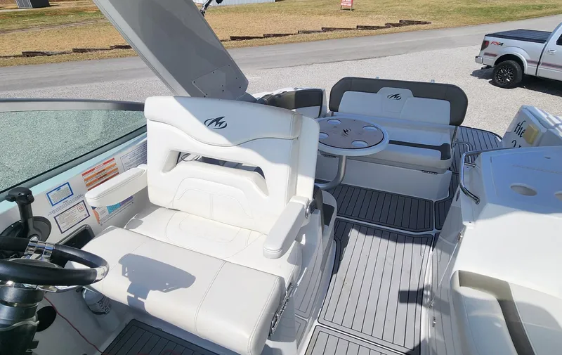 Slide: The Image of 2018 Monterey 275 Sport Yacht interior with white seating and steering wheel. - 8