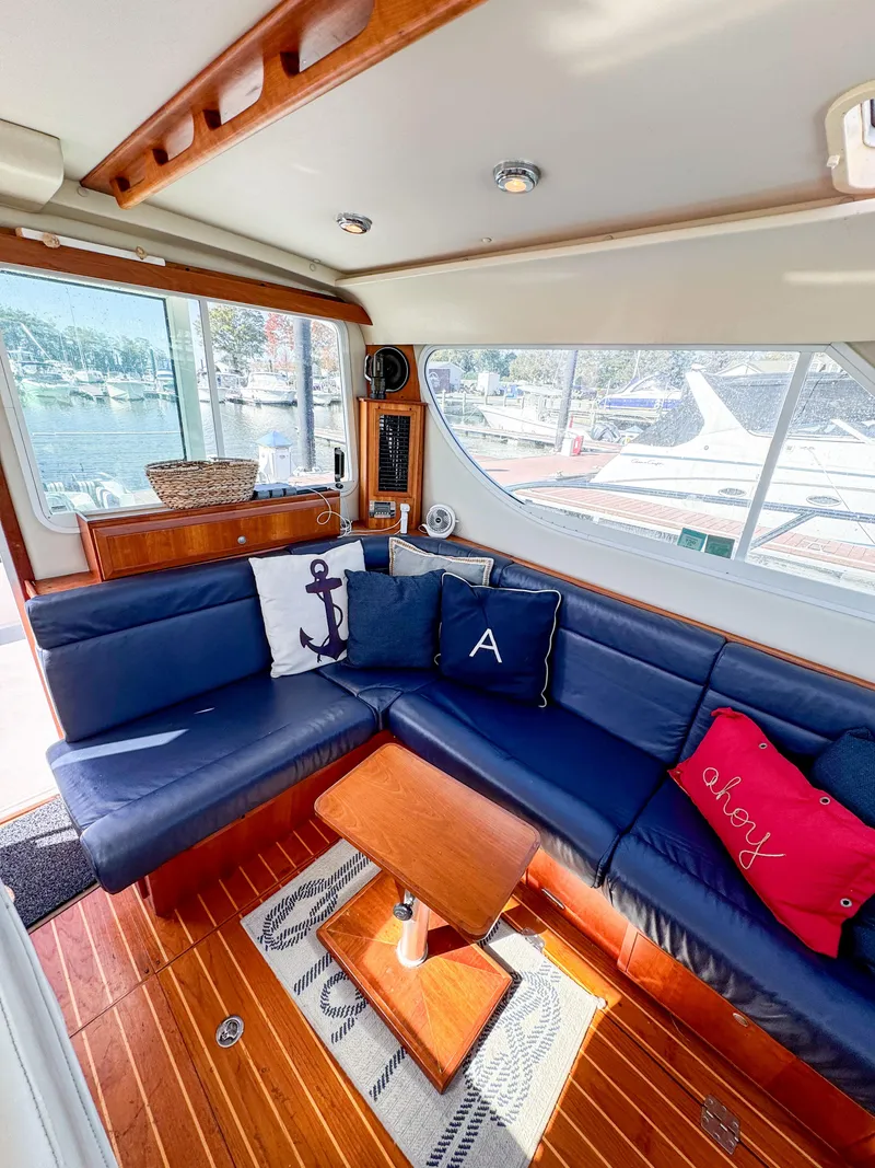 Slide: The Image of Luxurious 2005 Compton 33 yacht interior with blue seating and nautical-themed decor. - 6