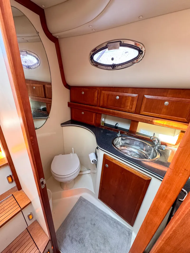 Slide: The Image of Luxurious bathroom in 2005 Compton 33 yacht with wood cabinetry and modern fixtures. - 8