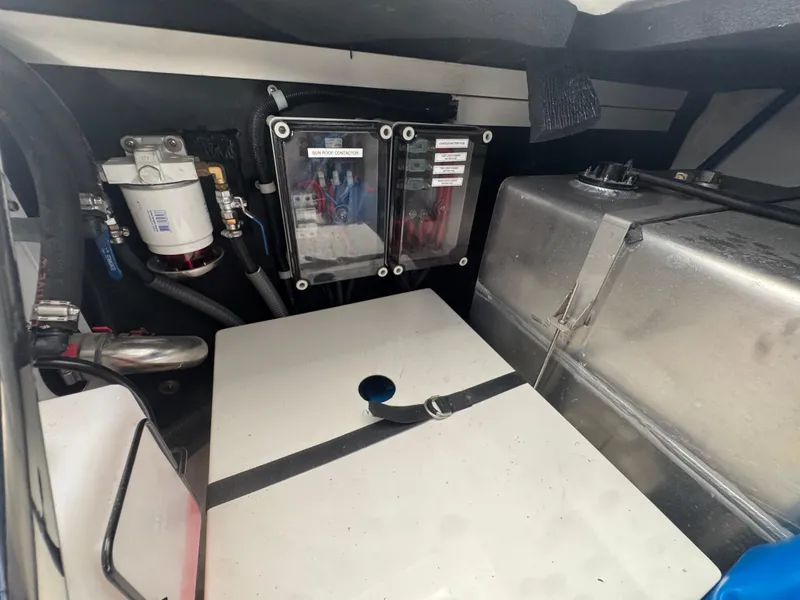 Slide: The Image of Engine compartment of 2023 Schaefer 375 HT boat, featuring fuel system and storage components. - 12