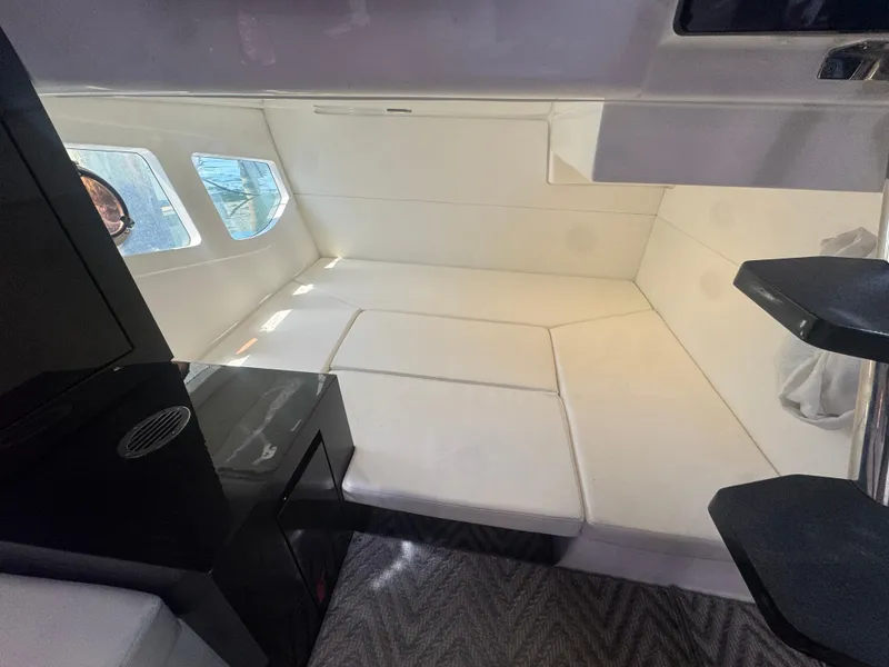 Slide: The Image of Interior of 2023 Schaefer 375 HT yacht with white seating and windows. - 16