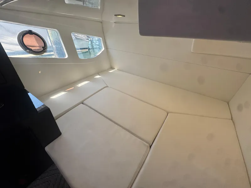 Slide: The Image of Interior cabin of 2023 Schaefer 375 HT yacht with beige seating and windows. - 17