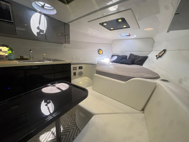 Slide: The Image of 2023 Schaefer 375 HT yacht interior with modern kitchen and cozy sleeping area. - 21