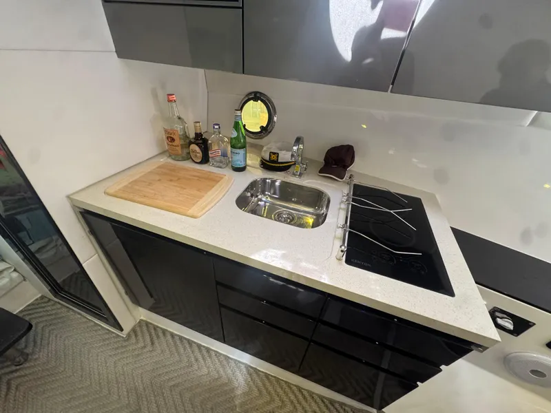 Slide: The Image of Modern kitchen in 2023 Schaefer 375 HT yacht with sink, stove, and countertop. - 24