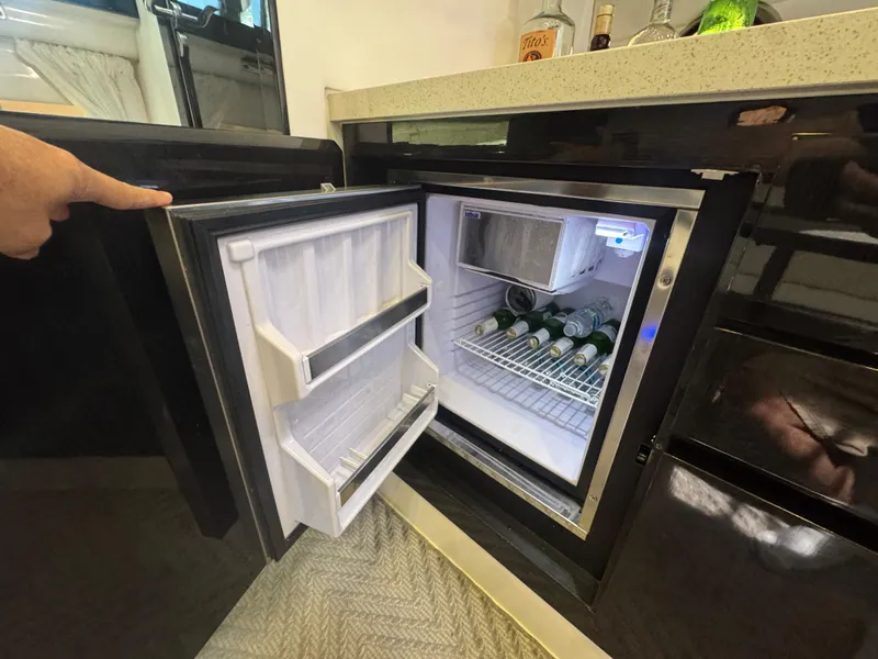 Slide: The Image of Mini fridge in 2023 Schaefer 375 HT yacht, stocked with beverages. - 25