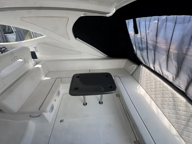 Slide: The Image of 2023 Schaefer 375 HT yacht interior with white seating and a central table. - 29