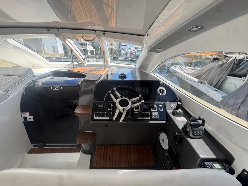 Slide: The Image of Interior of 2023 Schaefer 375 HT yacht with modern helm and wooden accents. - 31