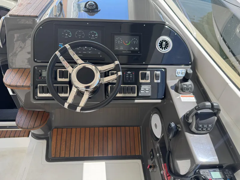 Slide: The Image of 2023 Schaefer 375 HT yacht helm with modern controls and wooden accents. - 32