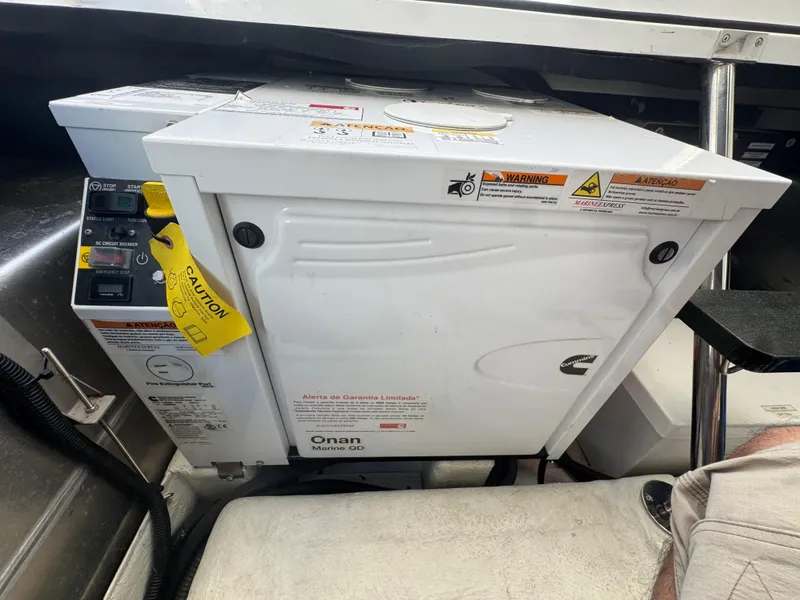 Slide: The Image of Onan marine generator inside a 2023 Schaefer 375 HT boat. - 38