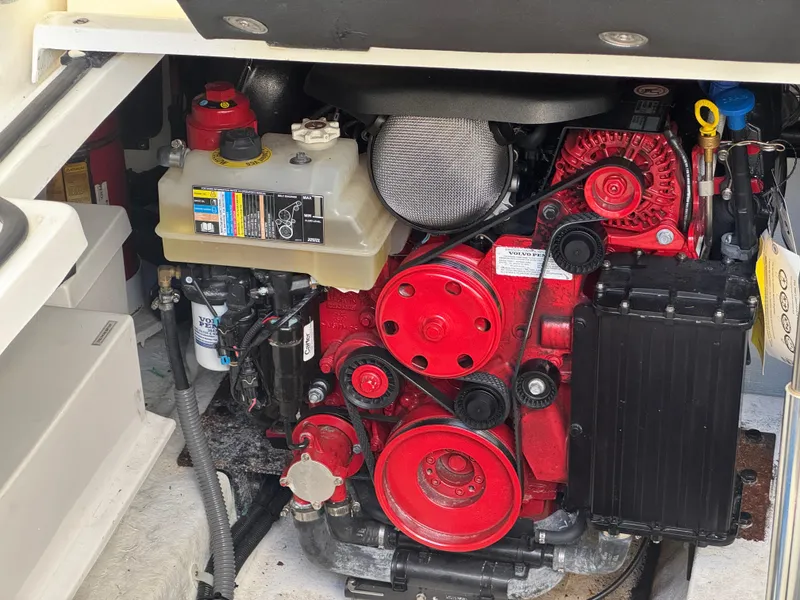 Slide: The Image of Engine compartment of 2023 Schaefer 375 HT boat, featuring red components and fluid reservoirs. - 40
