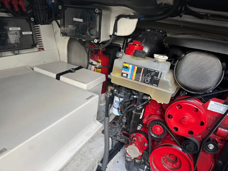 Slide: The Image of Engine compartment of 2023 Schaefer 375 HT boat, featuring red components and safety equipment. - 41