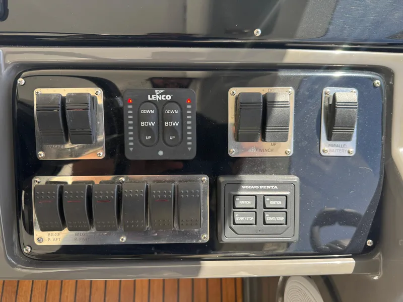 Slide: The Image of Control panel of 2023 Schaefer 375 HT boat with switches and Lenco trim tab controls. - 45