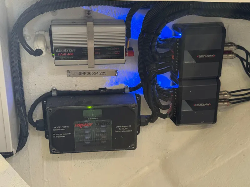 Slide: The Image of Electrical components inside a 2023 Schaefer 375 HT boat, featuring Unitron Volt-400 and other devices. - 49