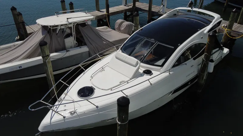 Slide: The Image of 2023 Schaefer 375 HT yacht docked at marina, sleek design, white exterior. - 5