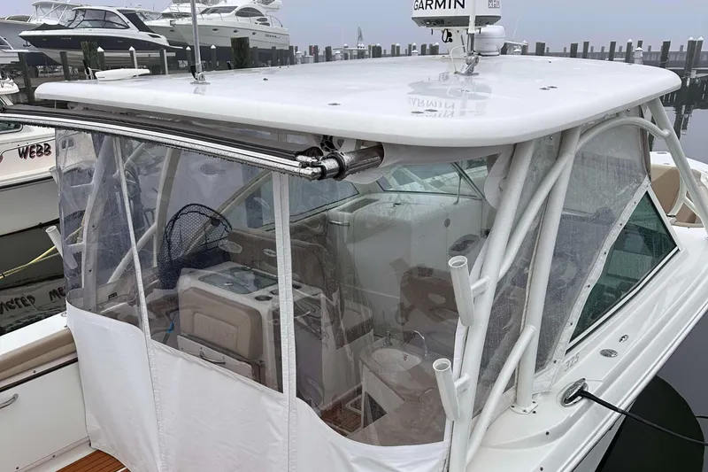 Slide: The Image of 2019 Sailfish 325 DC boat with enclosed cockpit, docked at marina. - 1