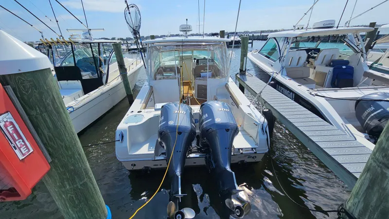 Slide: The Image of 2019 Sailfish 325 DC boat docked with twin outboard engines. - 11
