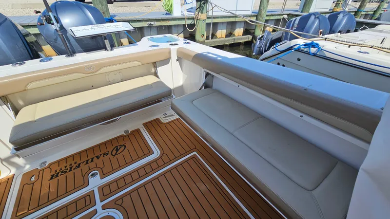 Slide: The Image of 2019 Sailfish 325 DC boat interior with cushioned seating and teak flooring. - 14