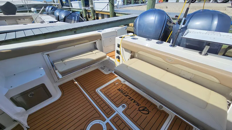 Slide: The Image of 2019 Sailfish 325 DC boat interior with cushioned seating and teak flooring. - 15