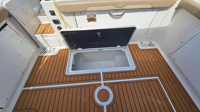 Slide: The Image of 2019 Sailfish 325 DC boat deck with open storage compartment. - 16