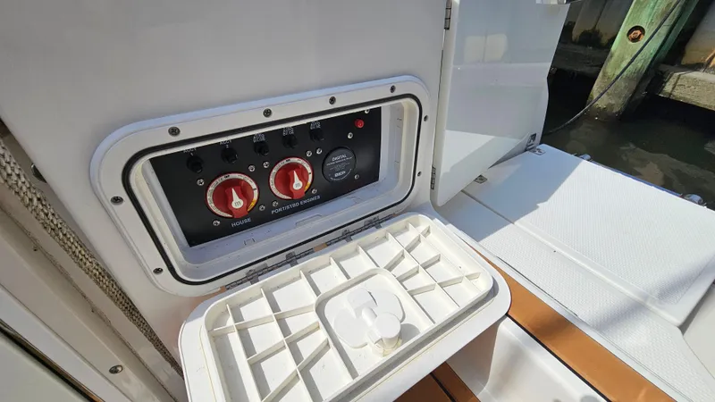Slide: The Image of Control panel on 2019 Sailfish 325 DC boat, featuring switches and dials. - 18