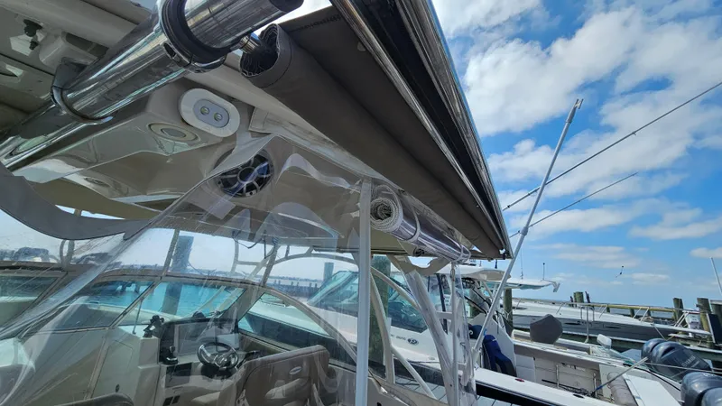Slide: The Image of 2019 Sailfish 325 DC boat docked under a clear blue sky. - 20