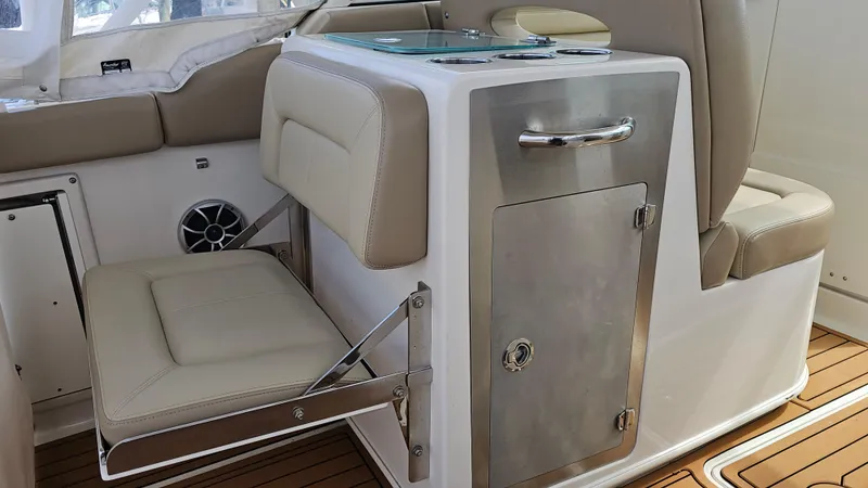 Slide: The Image of 2019 Sailfish 325 DC boat interior with foldable seat and storage compartment. - 22