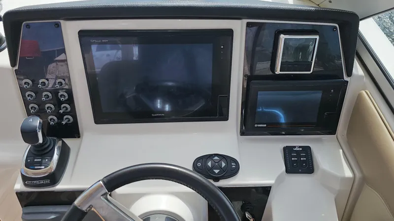 Slide: The Image of Control panel of 2019 Sailfish 325 DC boat with navigation screens and controls. - 26