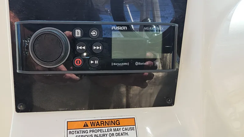 Slide: The Image of Fusion marine stereo on 2019 Sailfish 325 DC boat with safety warning label. - 28