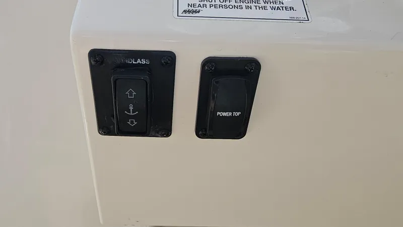 Slide: The Image of Control panel on 2019 Sailfish 325 DC boat with windlass and power top switches. - 29