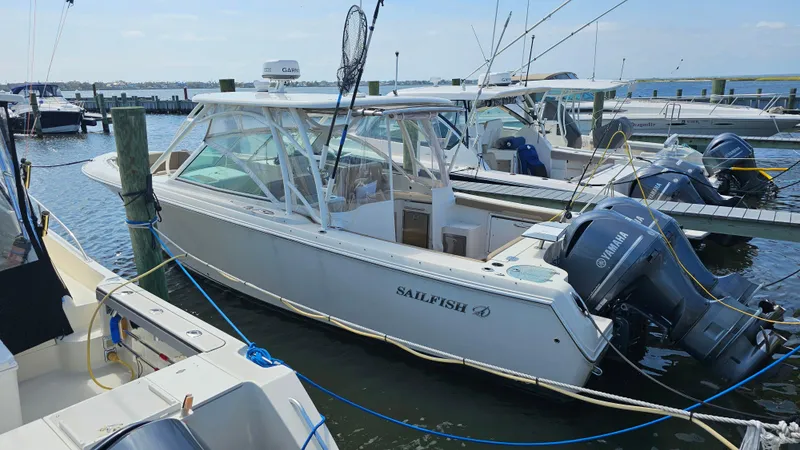 Slide: The Image of 2019 Sailfish 325 DC boat docked with Yamaha engines, ready for fishing. - 3