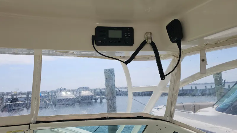 Slide: The Image of 2019 Sailfish 325 DC boat interior with radio, overlooking marina. - 32