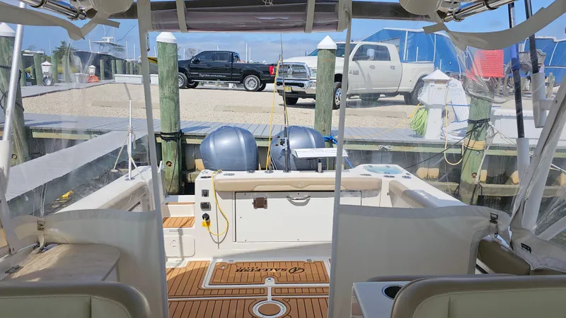 Slide: The Image of 2019 Sailfish 325 DC boat interior with dual outboard motors at dock. - 33