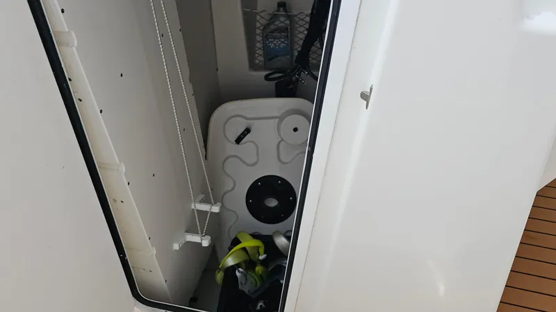 Slide: The Image of Storage compartment on a 2019 Sailfish 325 DC boat, featuring equipment and supplies. - 34