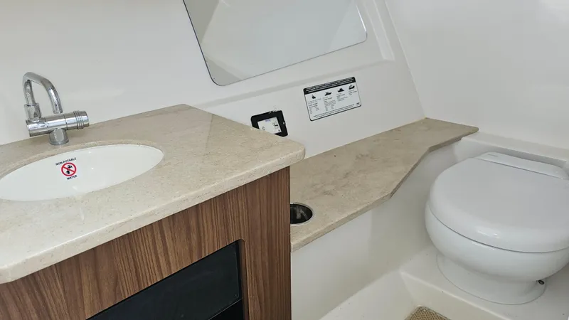 Slide: The Image of 2019 Sailfish 325 DC boat bathroom with sink and toilet. - 35
