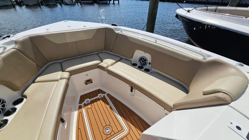 Slide: The Image of 2019 Sailfish 325 DC boat interior with tan seating and wood flooring. - 37